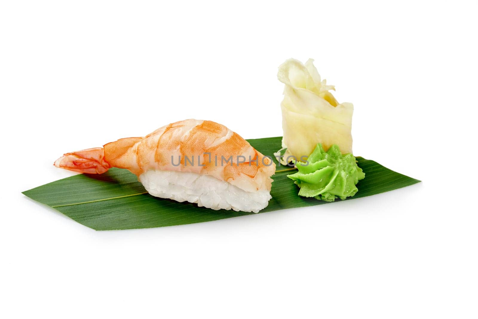 Shrimp sushi nigiri with wasabi and pickled ginger on bamboo leaf by nazarovsergey