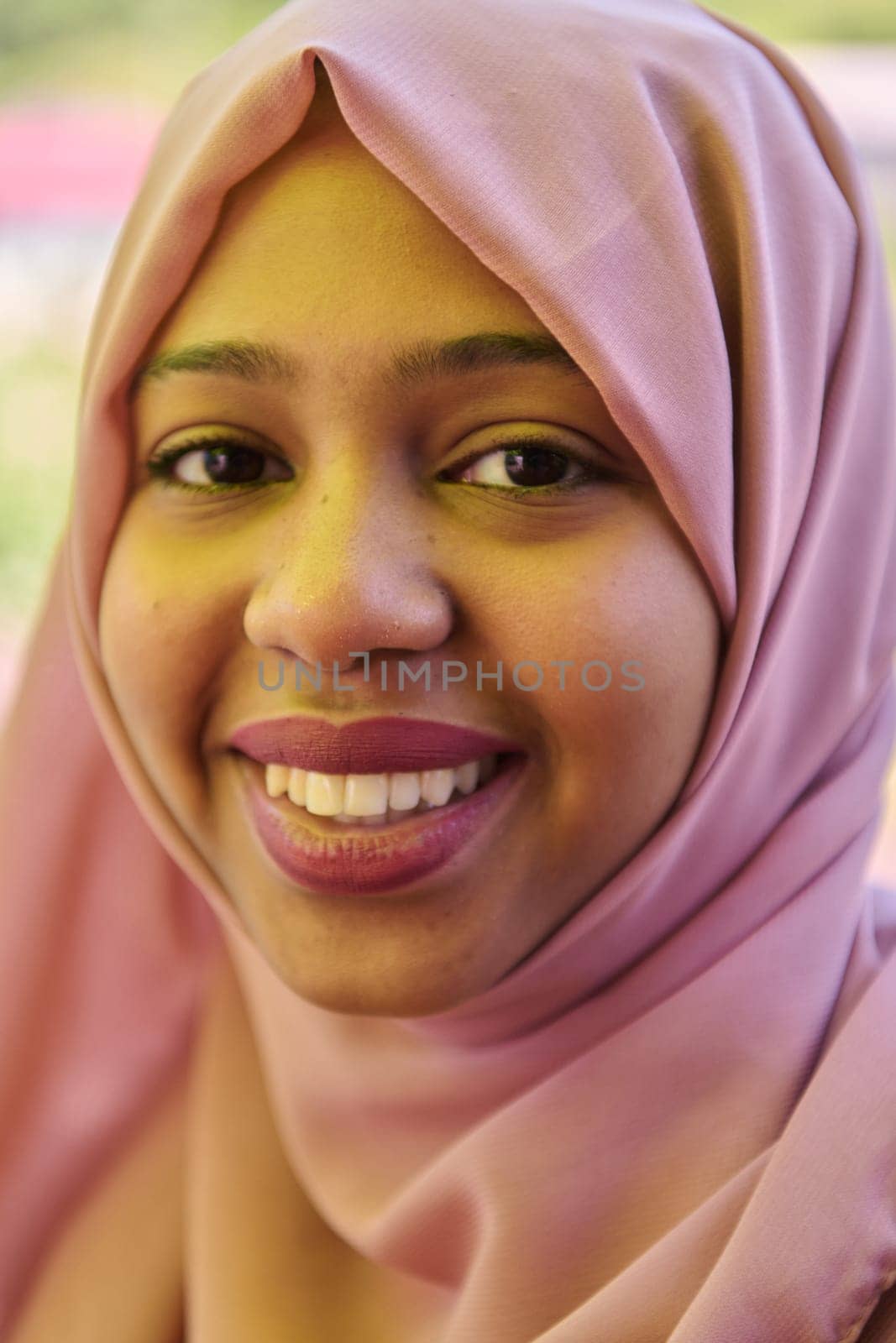 Close up Portrait of a Joyful Middle Eastern Hijabi by dotshock