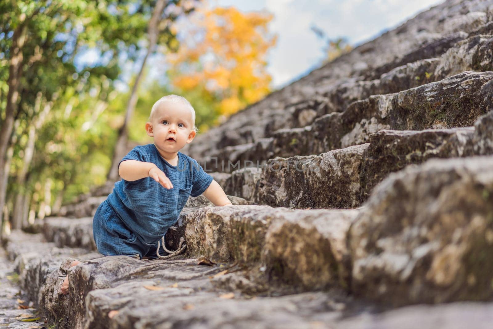 Baby tourist at Coba, Mexico. Ancient mayan city in Mexico. Coba is an archaeological area and a famous landmark of Yucatan Peninsula. Cloudy sky over a pyramid in Mexico by galitskaya