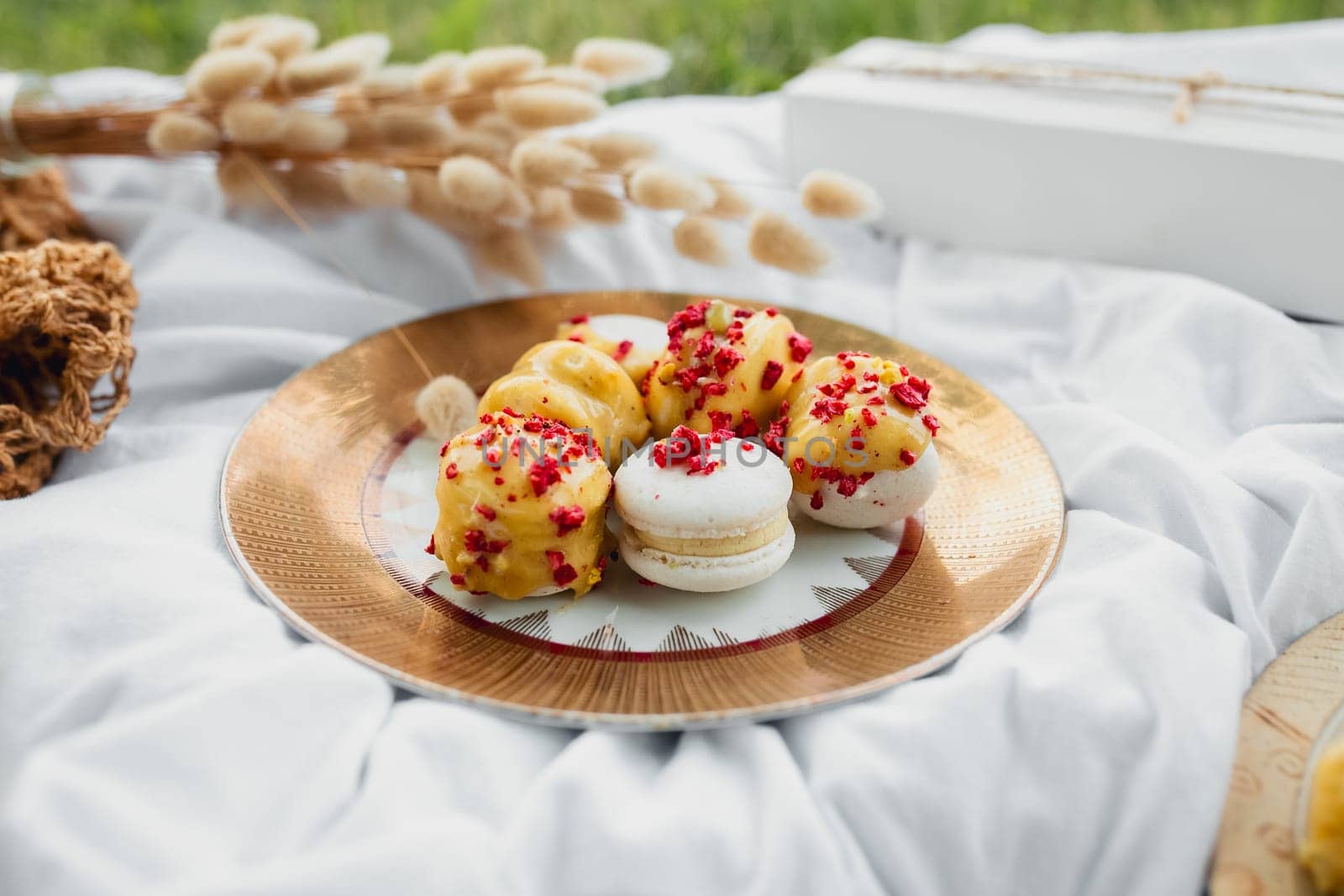 A plate of colorful macarons resting delicately on a pristine white blanket, creating a delightful and visually appealing scene.