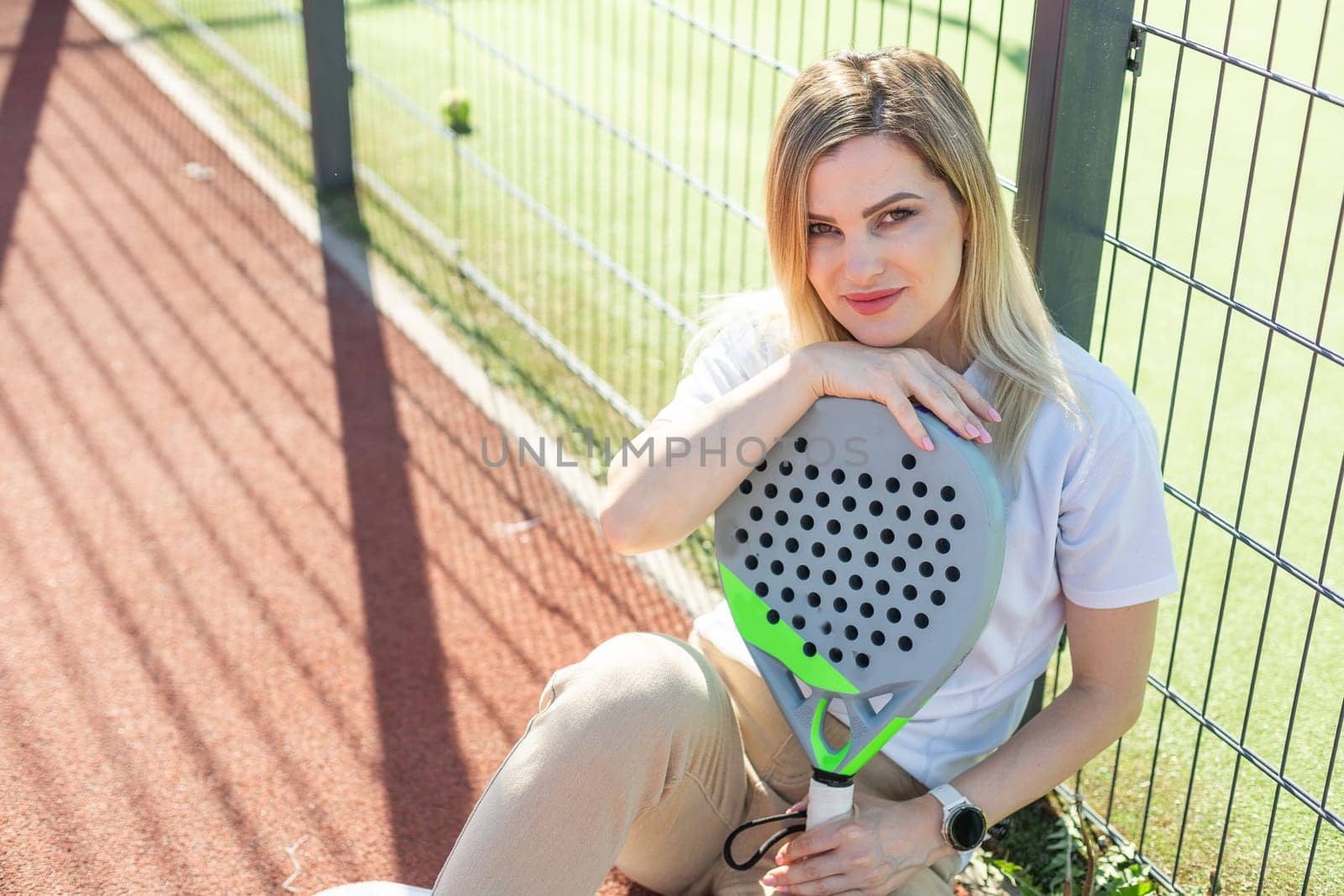 A female paddle tennis player after playing a match. High quality photo