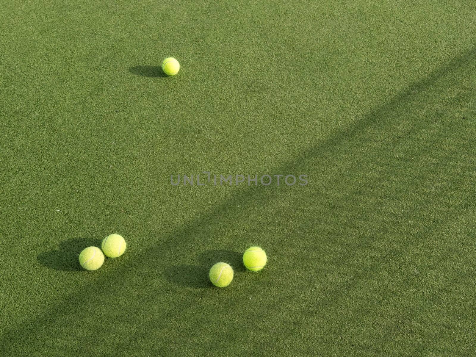 Tennis balls are on green grass by Andelov13