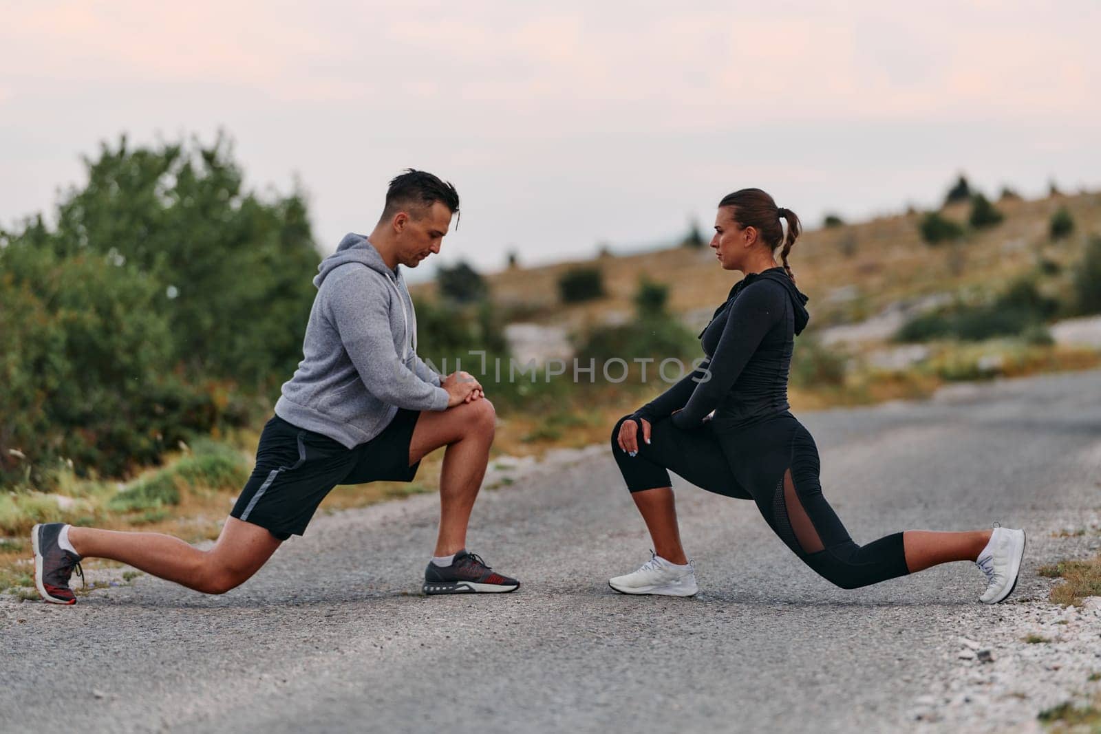 A romantic couple stretches after a tiring morning run