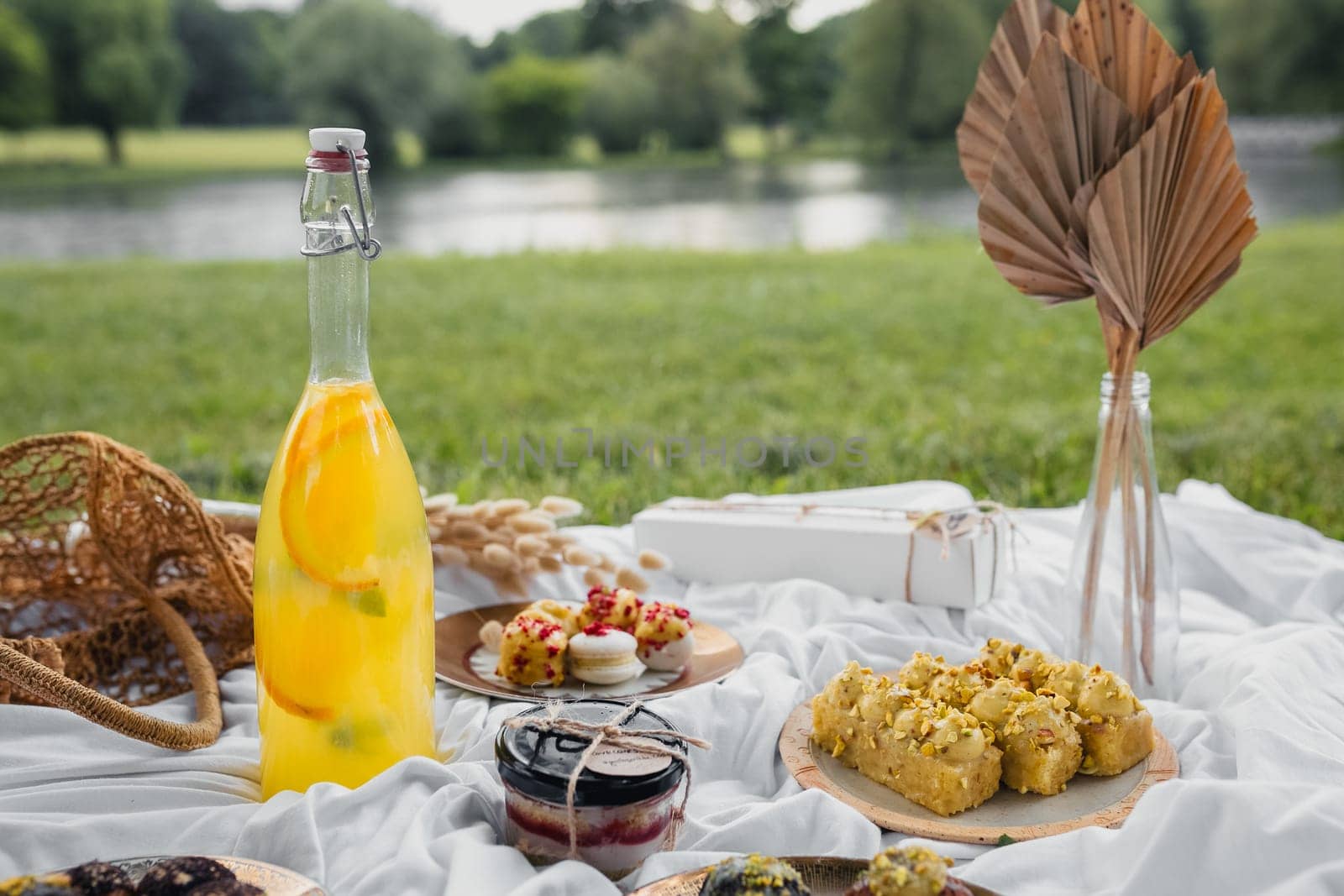 A picnic basket overflowing with delectable food and drinks, ready for a relaxing outdoor meal in nature.
