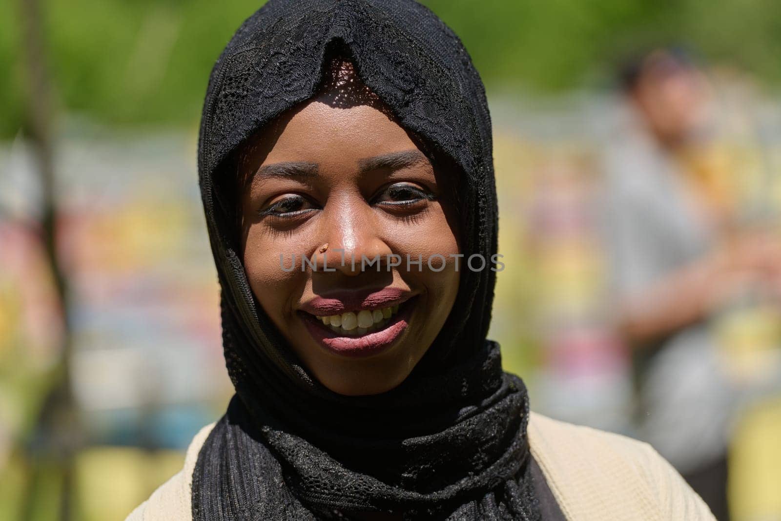 A Middle Eastern Muslim woman in a hijab beams with a radiant smile in a picturesque natural apiary, exuding joy and harmony