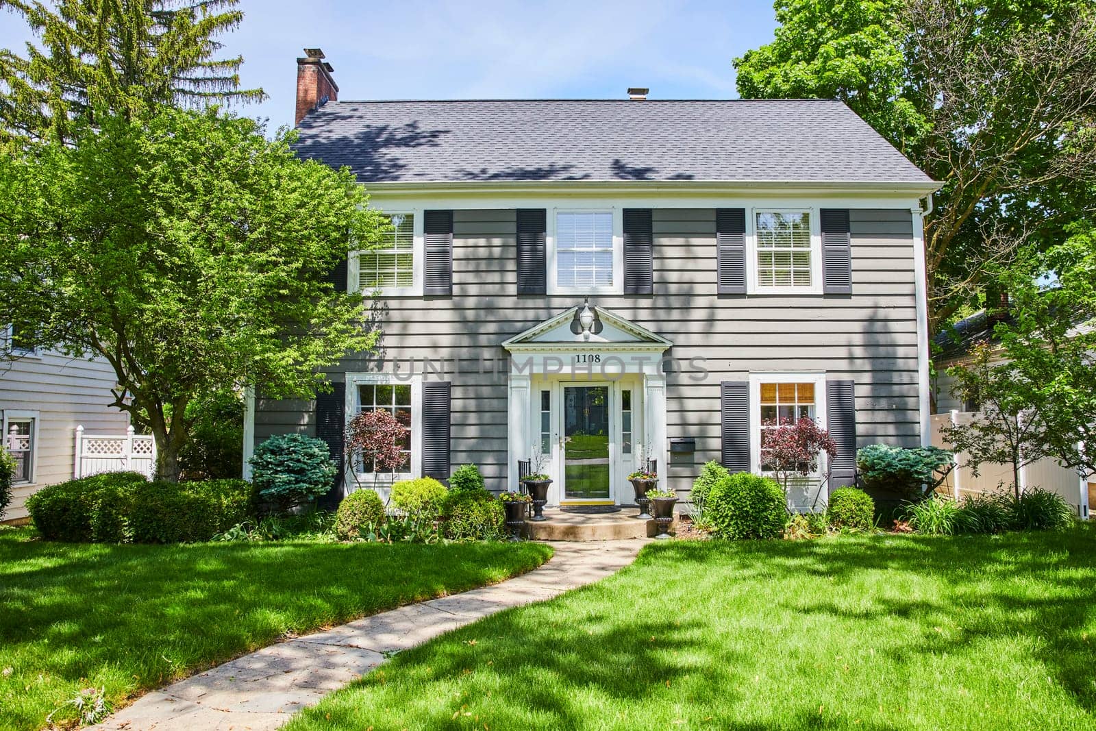 Bright sunny day at a charming, traditional home in South Wayne Historic District, Indiana, perfect for family living.