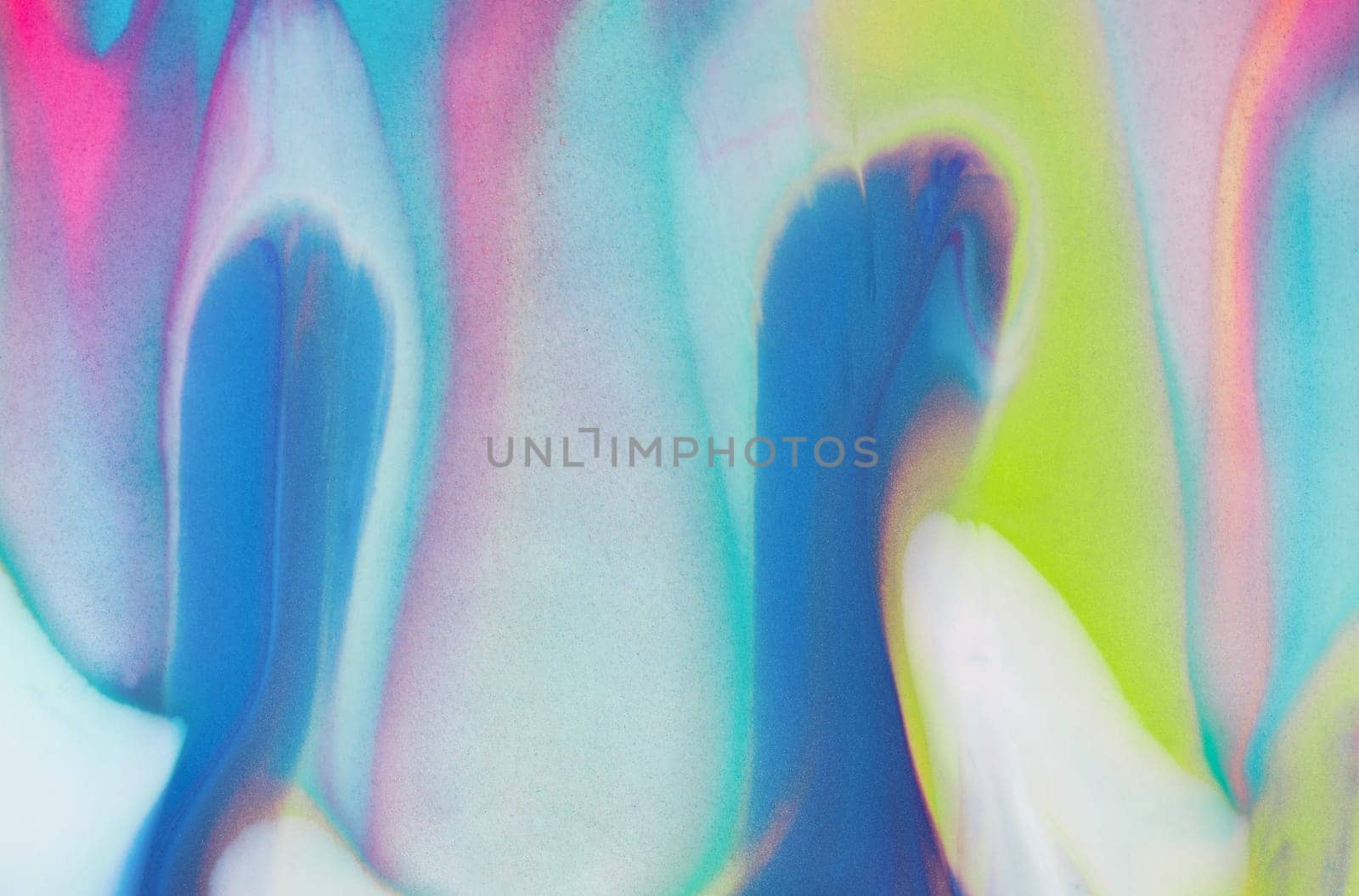 Swirls of vibrant blue, pink, and white merge fluidly, resembling an abstract wave under the soft, glowing light of late afternoon.