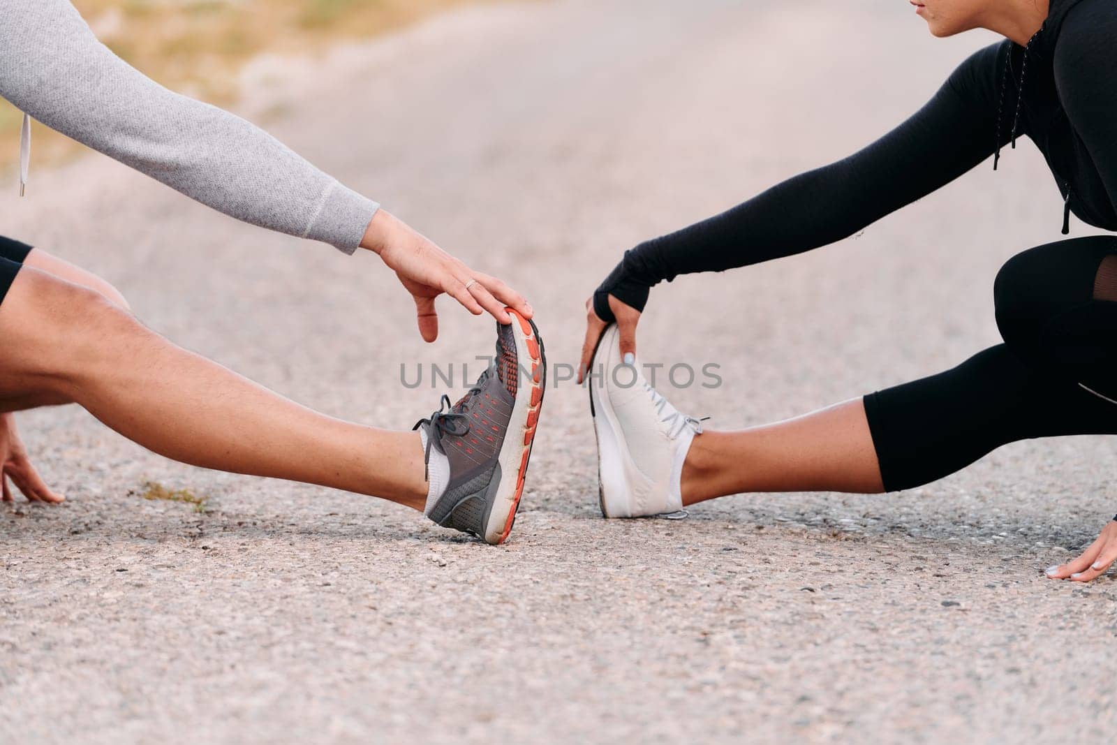 A romantic couple stretches after a tiring morning run