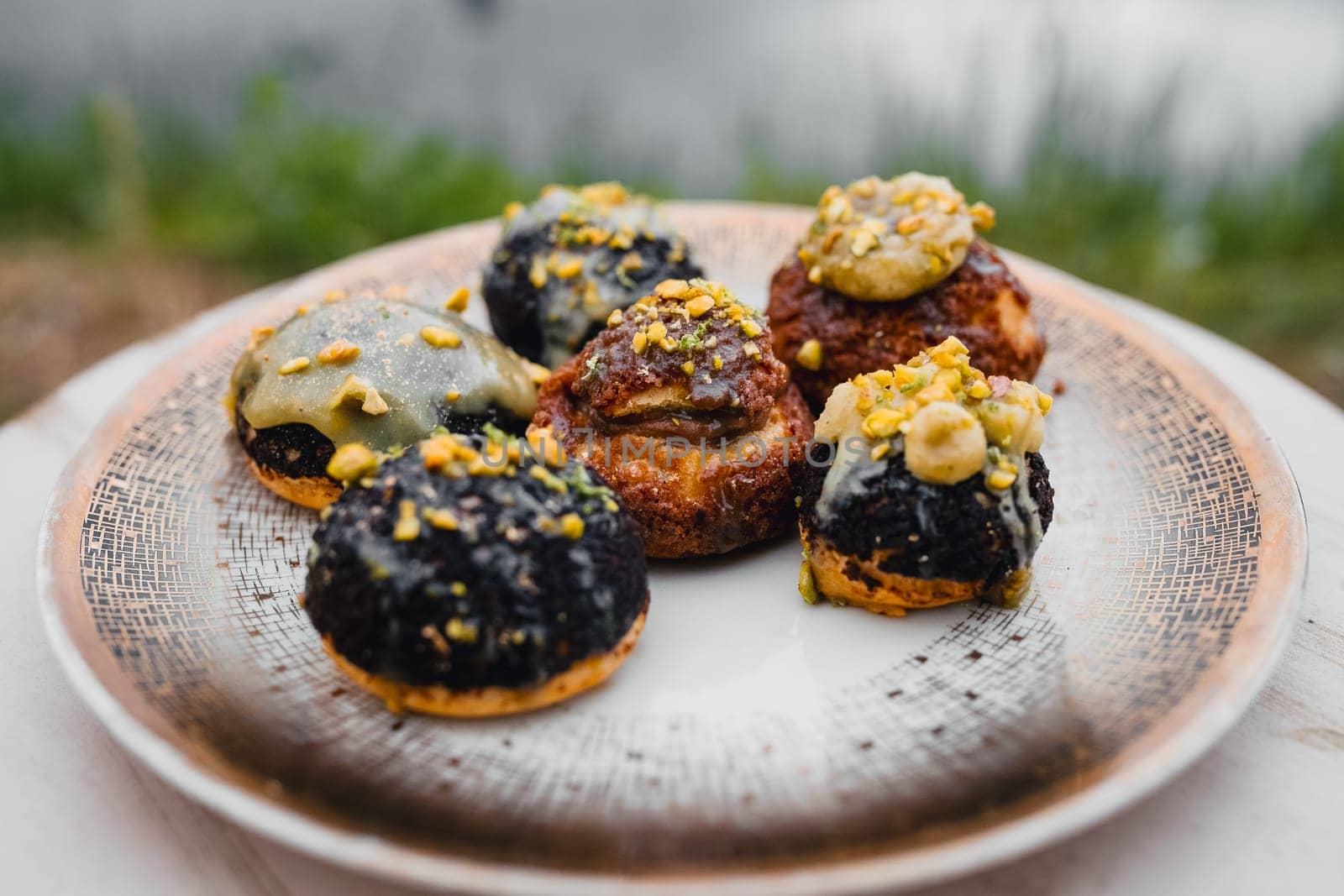 A plate displaying a diverse assortment of freshly baked pastries, by Miron