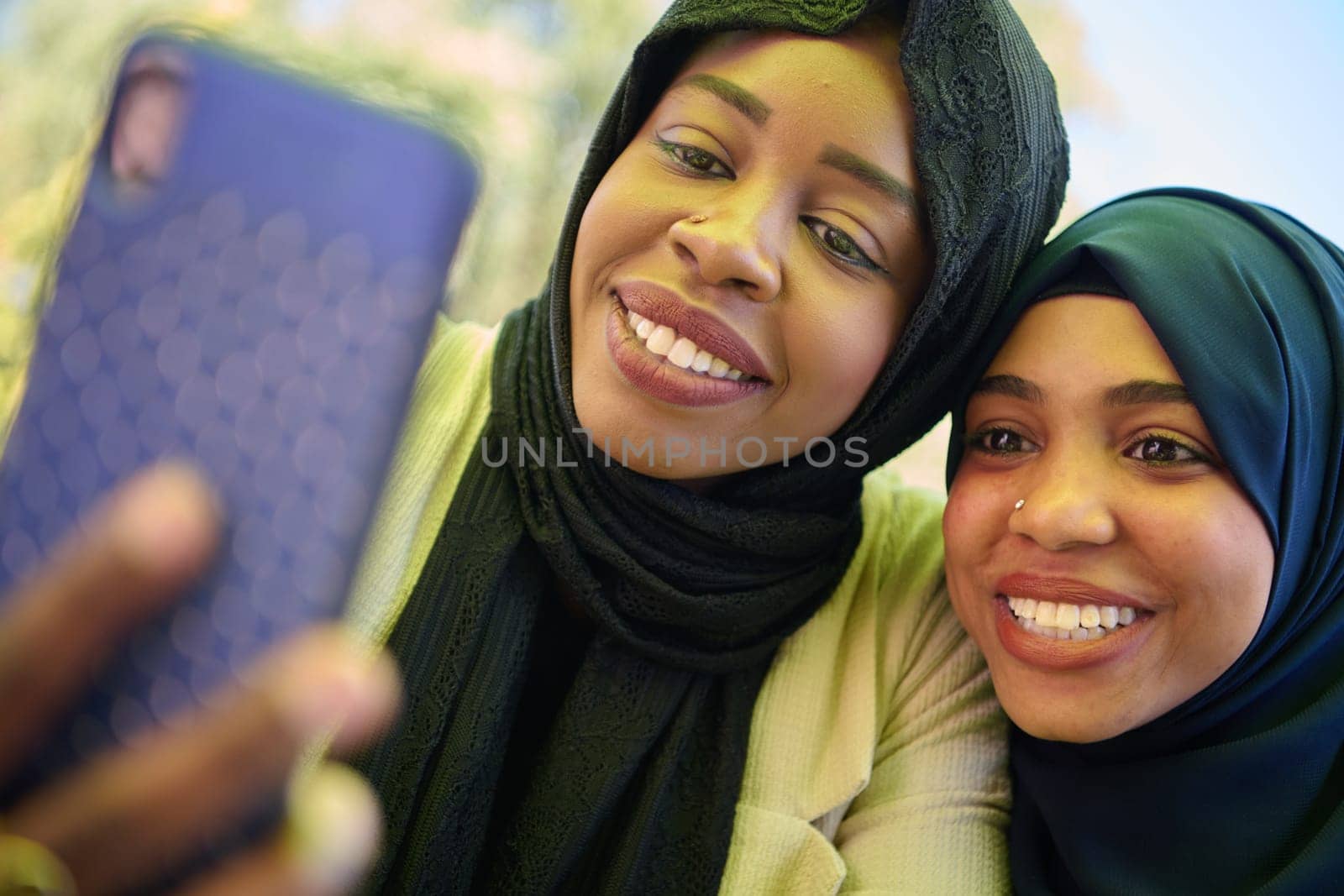 Middle Eastern Muslim Women Capturing Selfies in Serene Surroundings by dotshock