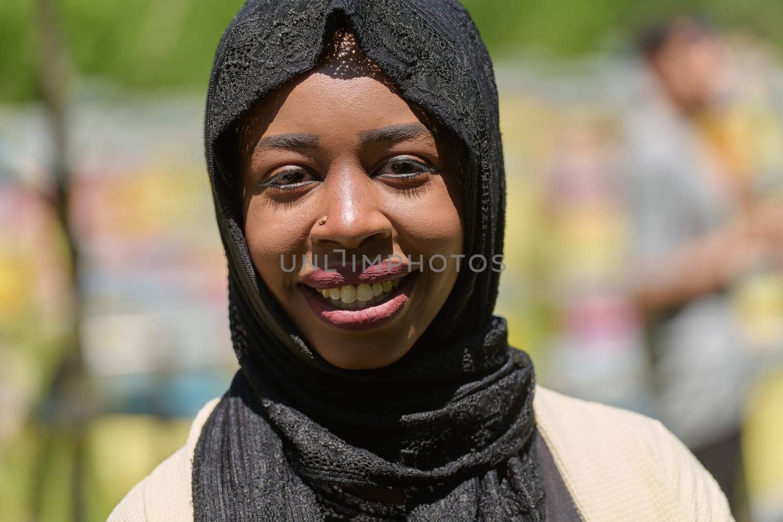 A Middle Eastern Muslim woman in a hijab beams with a radiant smile in a picturesque natural apiary, exuding joy and harmony