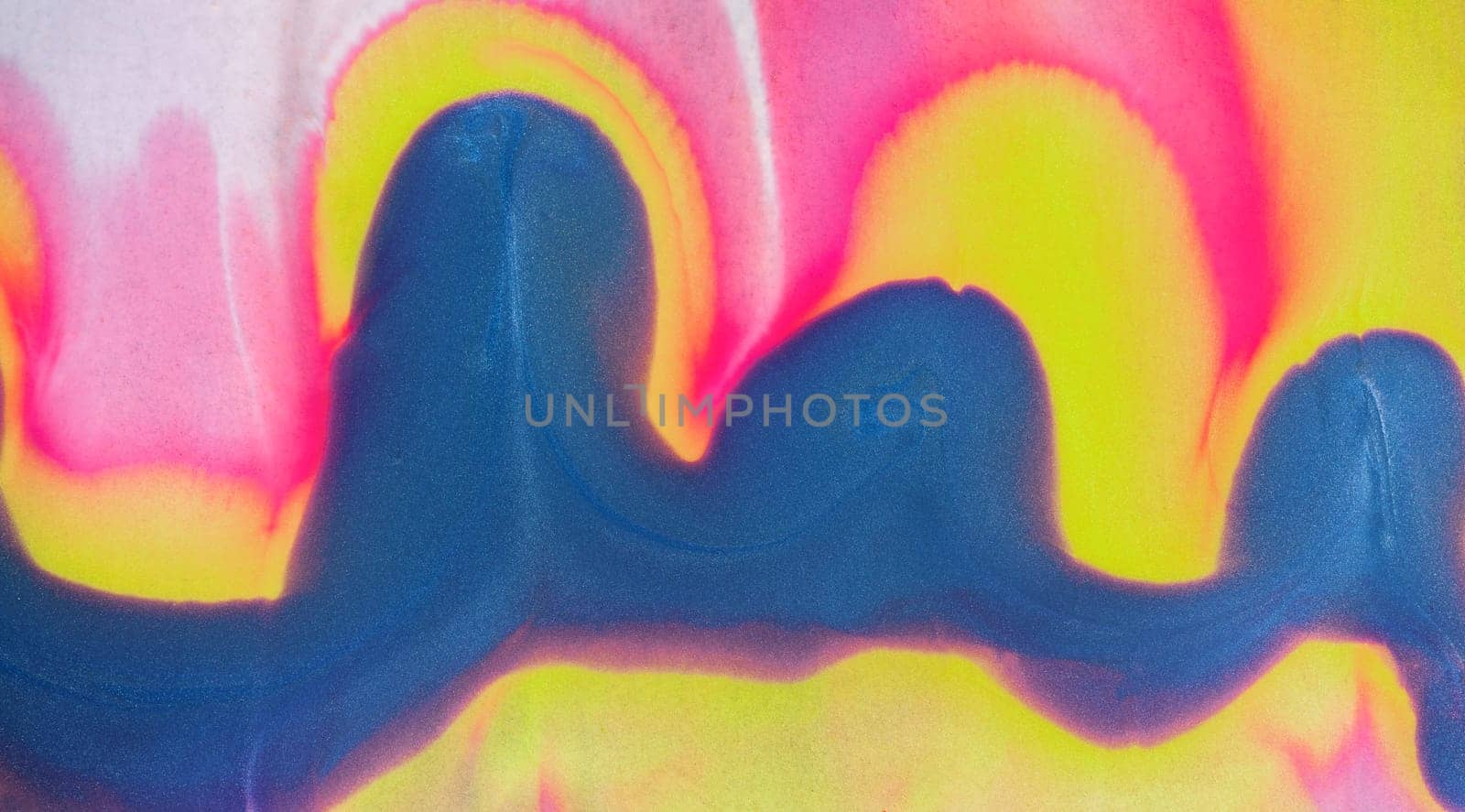Swirls of vibrant blue, pink, and white merge fluidly, resembling an abstract wave under the soft, glowing light of late afternoon.