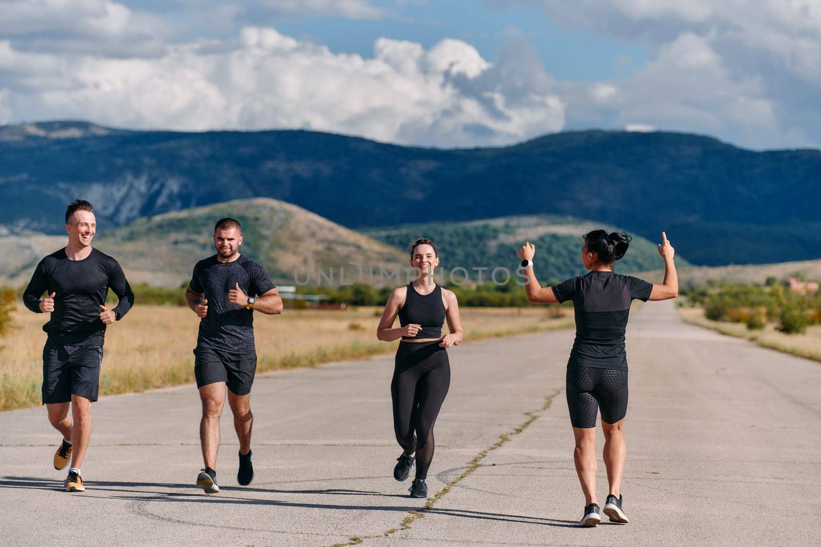 A professional athletic team as they train rigorously, running towards peak performance in preparation for an upcoming marathon.