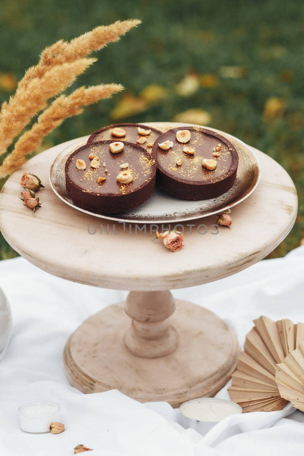 A delicious cake placed on a plate, adorned with a whimsical fan decoration, creating a unique and artistic dessert display.