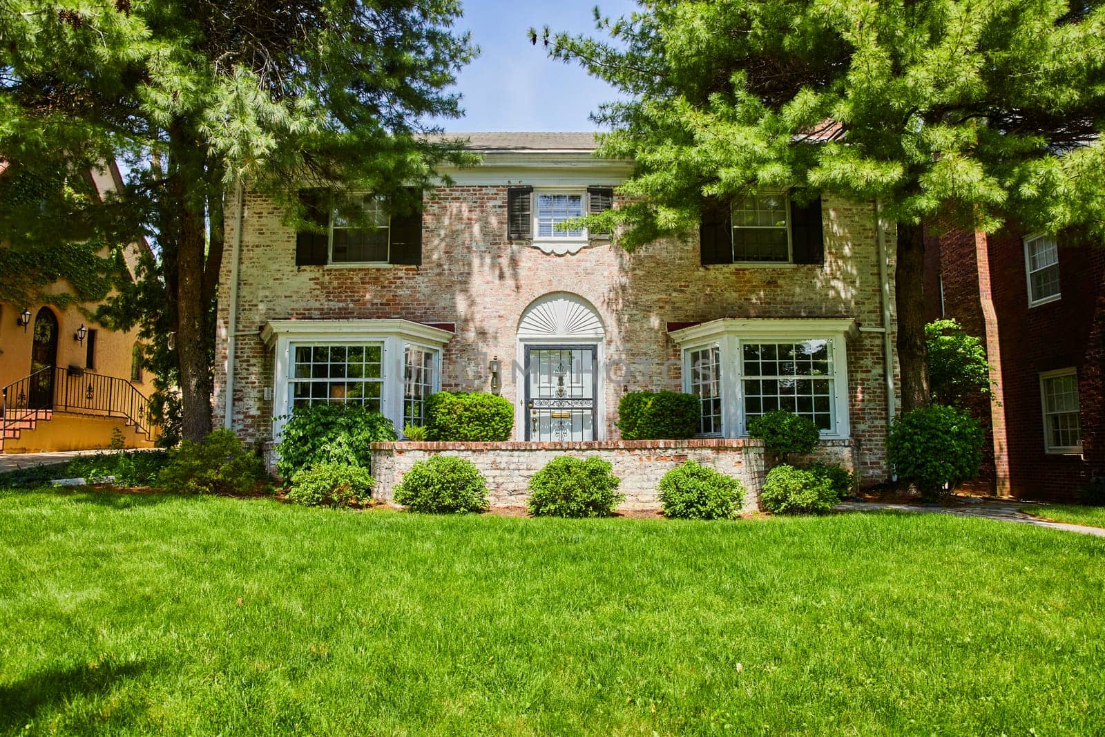 Charming brick home in lush Fort Wayne historic district, ideal for serene suburban living.