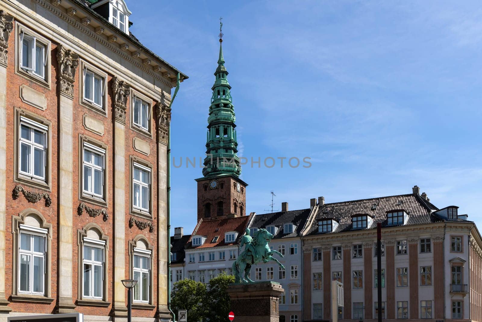 Downtown Copenhagen with old houses and church on a sunny day.