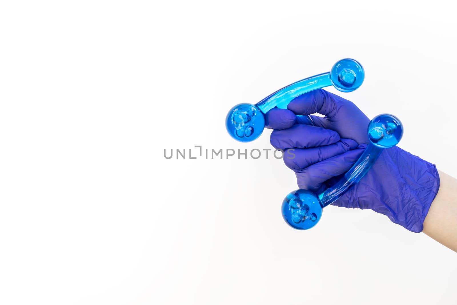 Mockup Human Gloved Hand Holds Blue Acrylic Back, Leg, Neck Massage Tool. Deep Tissue Massage, Thumb Massager with Knobs for Gentle Point, Muscles Relaxation. Design, Copy Space. Horizontal Plane.