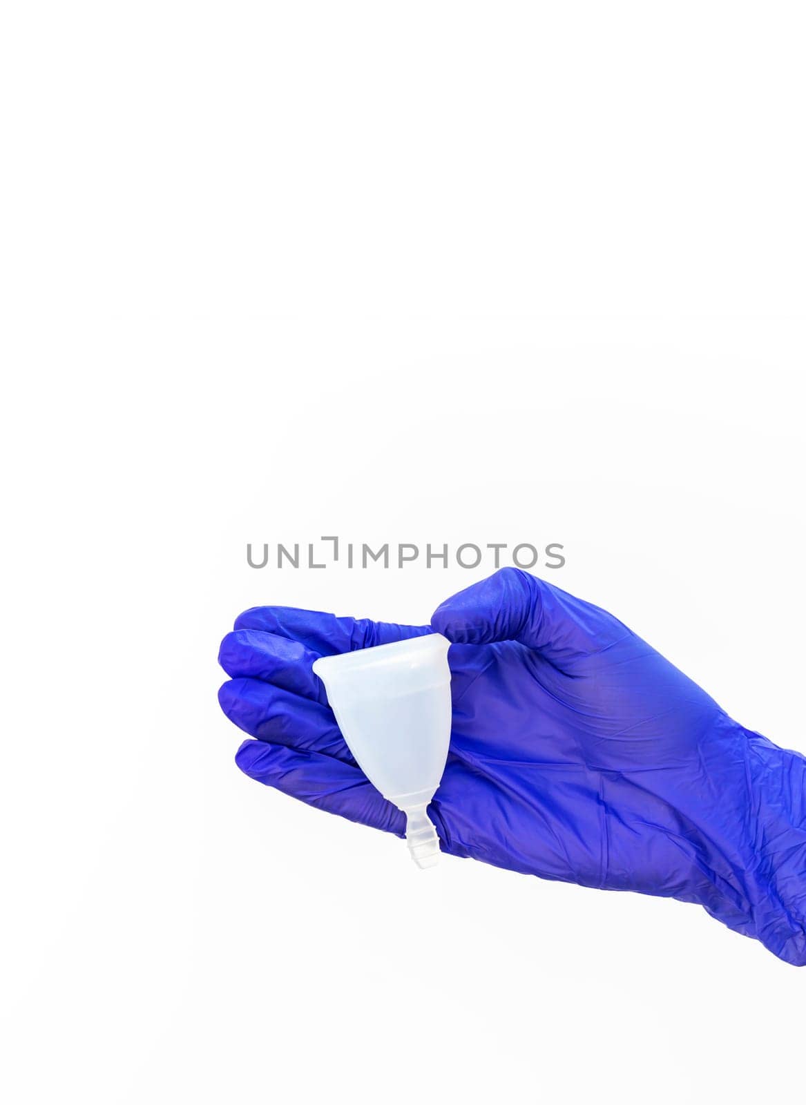 Design World Menstrual Hygiene Day On May, 28. Isolated Human Hand in Glove Holds Menstrual Cup on White Background. Backdrop Copy Space, Vertical Plane, Design. High quality photo
