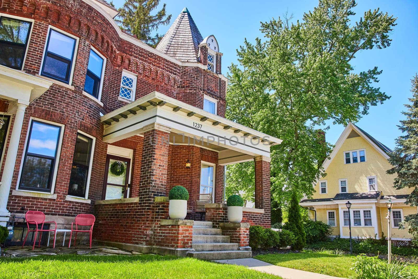 Elegant red brick Victorian-Colonial house in Fort Wayne, Indiana, showcasing historic suburban charm.