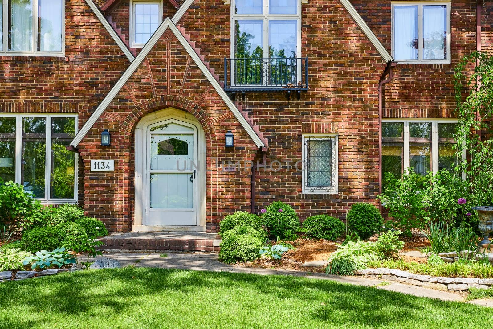 Charming Tudor-style brick home in Fort Wayne's historic South Wayne district, beautifully landscaped.