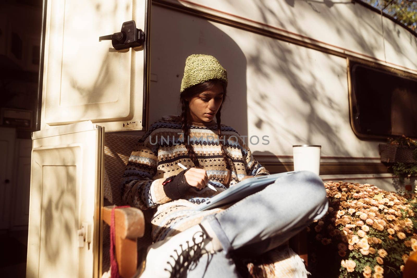 n enchanting lady exudes bohemian vibes against the park scenery, with a trailer in the background. High quality photo