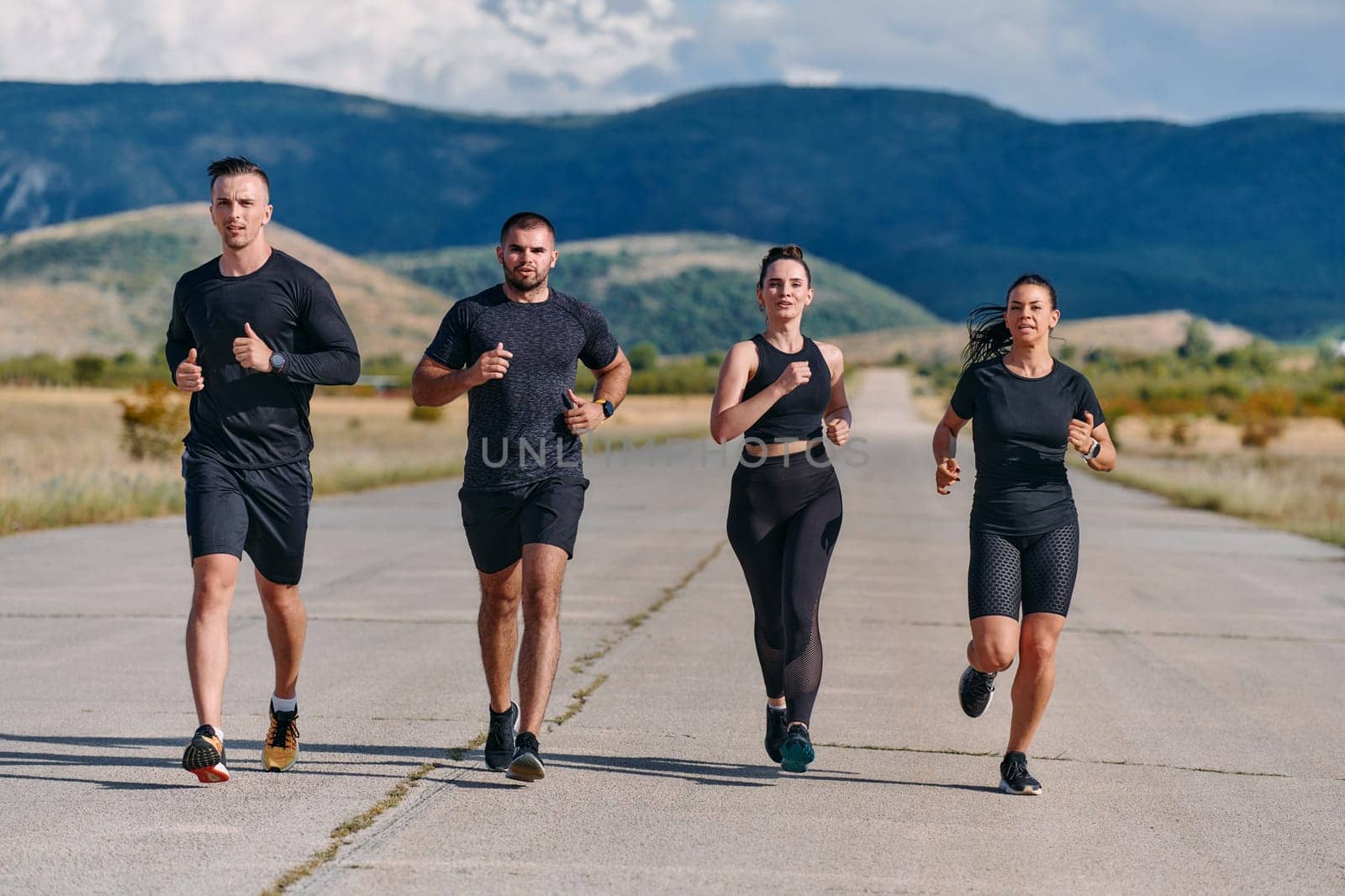 A professional athletic team as they train rigorously, running towards peak performance in preparation for an upcoming marathon.