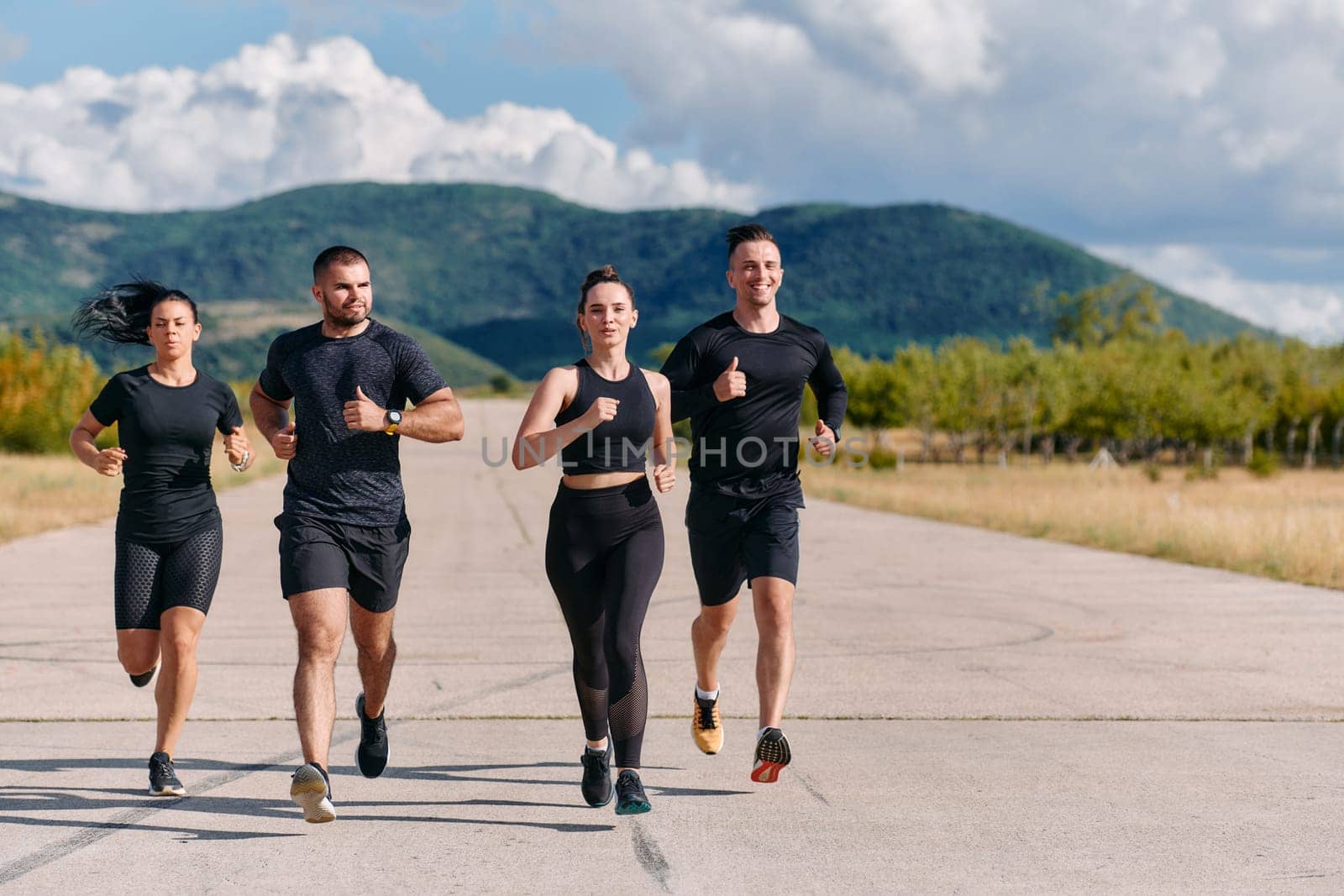 A professional athletic team as they train rigorously, running towards peak performance in preparation for an upcoming marathon.