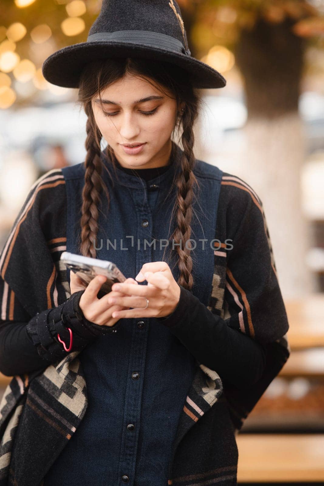 A fashionable, vibrant woman with a black hat and a braided hairdo. High quality photo