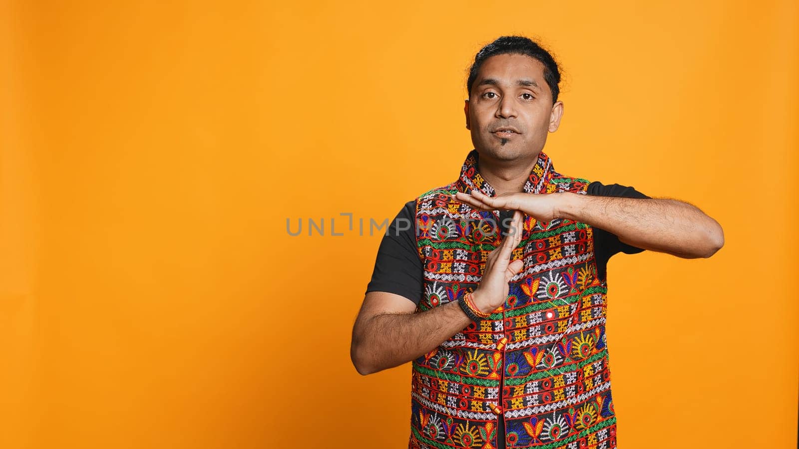 Firm person doing vehement pause sign gesturing, studio background by DCStudio