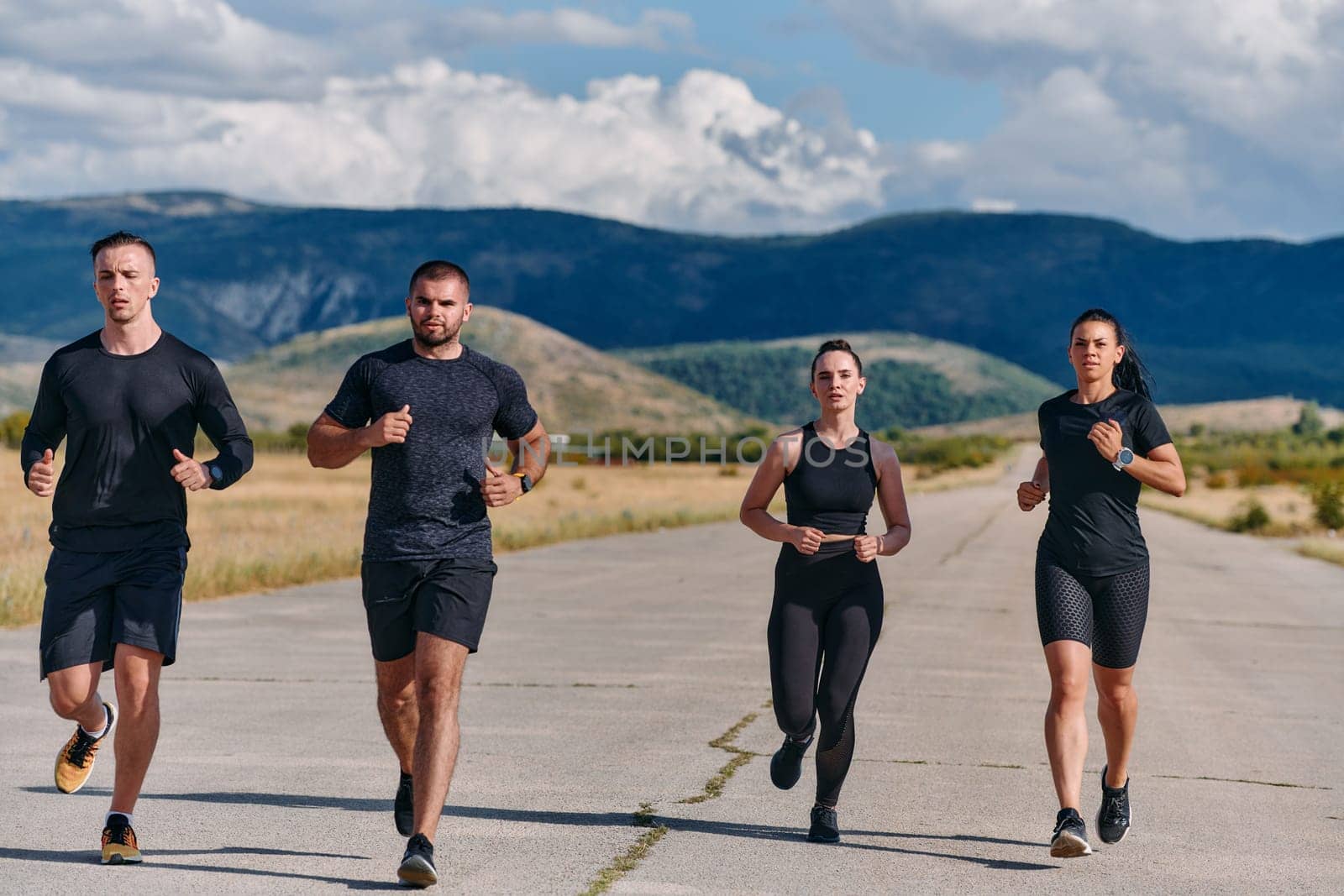 A professional athletic team as they train rigorously, running towards peak performance in preparation for an upcoming marathon.