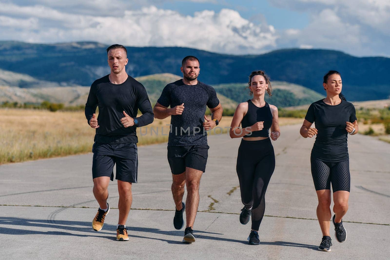 A professional athletic team as they train rigorously, running towards peak performance in preparation for an upcoming marathon.