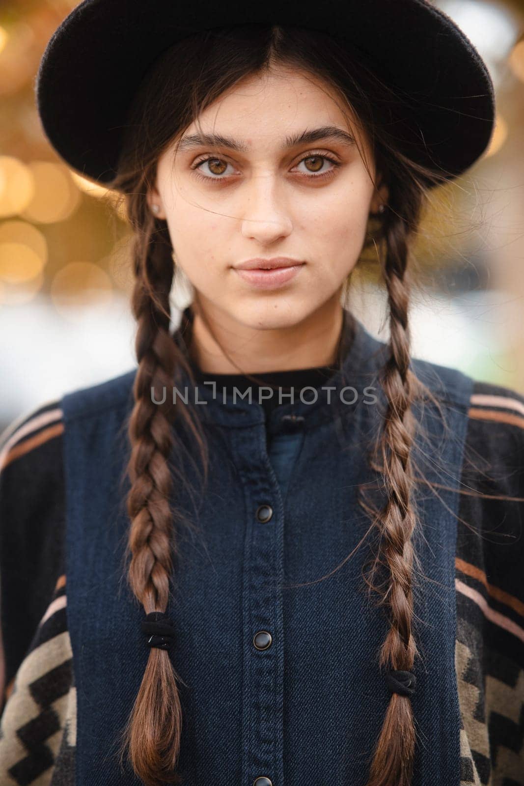 A stylish lady in black attire, complemented by a hat. High quality photo