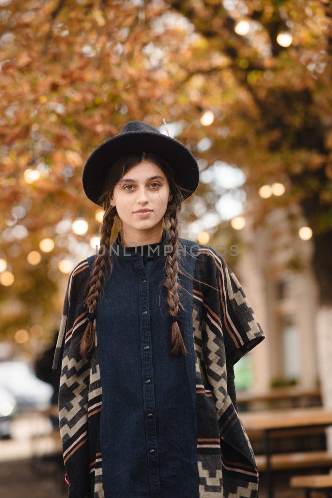 A sophisticated woman showcasing style in black attire and a hat. High quality photo