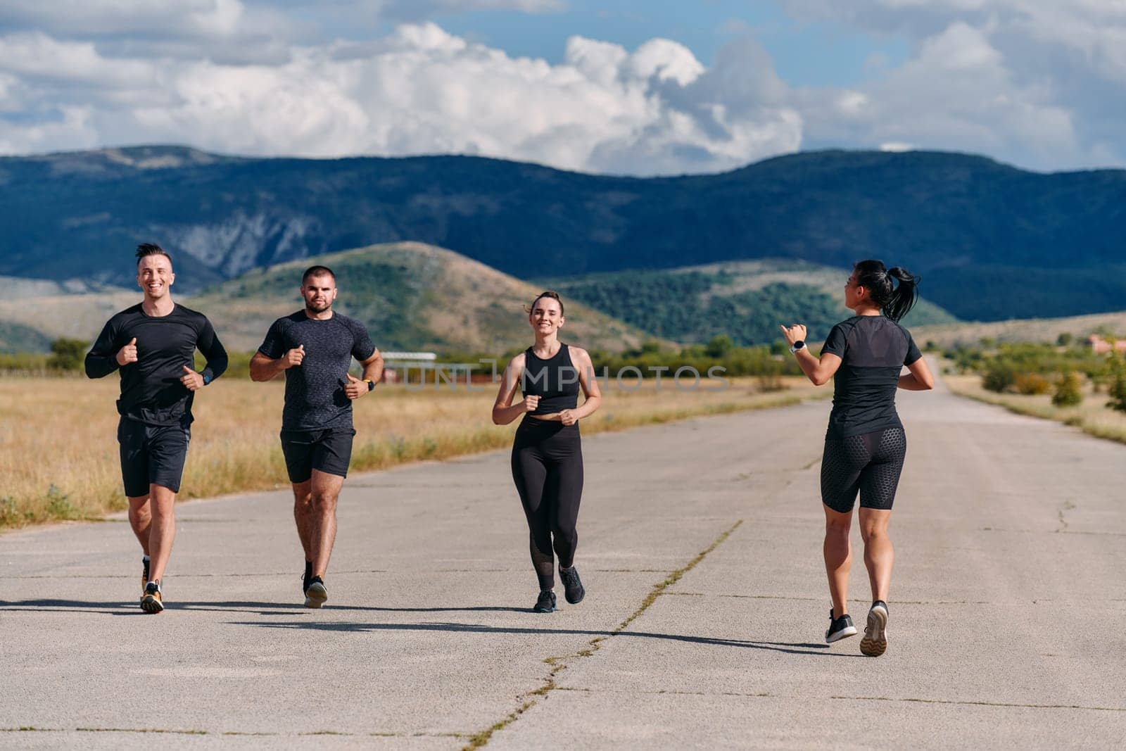 A professional athletic team as they train rigorously, running towards peak performance in preparation for an upcoming marathon.