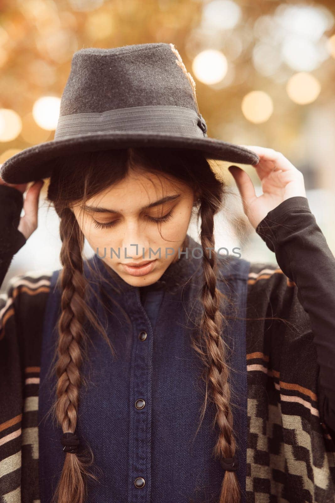 A graceful woman donning a black outfit and a fashionable hat. High quality photo