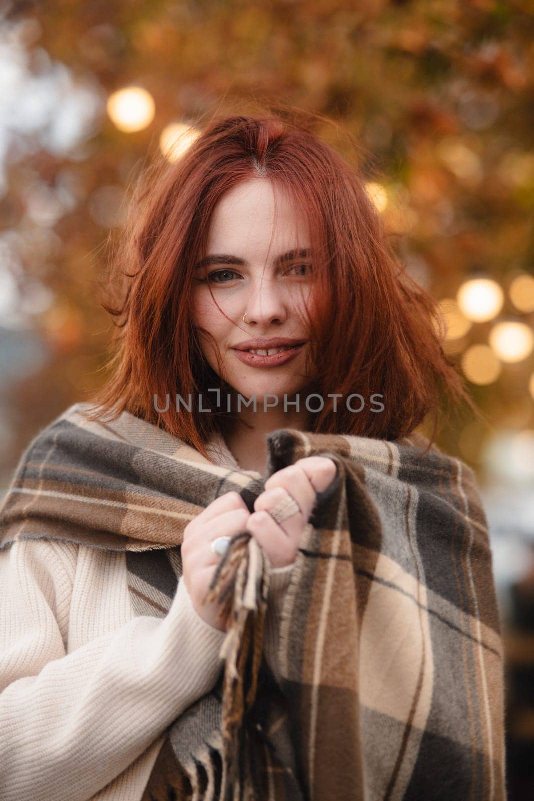 A spirited red-haired girl radiating hippie energy on a cool autumn day. High quality photo