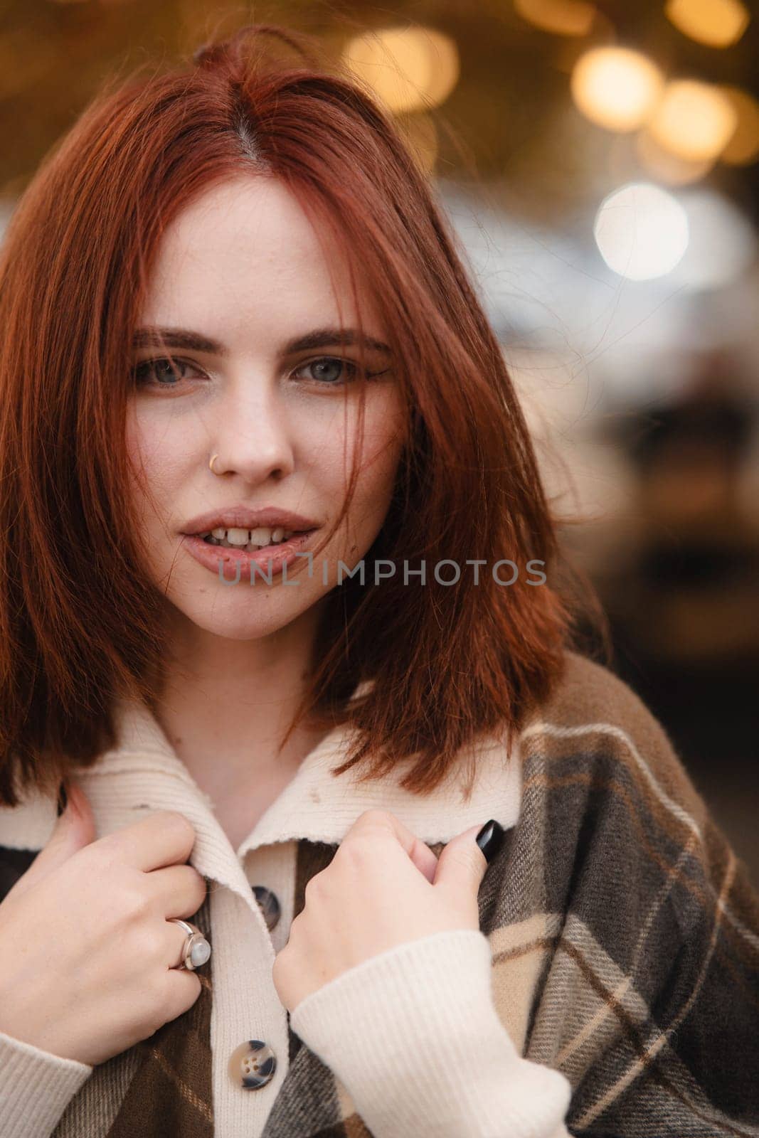 An enchanting red-haired lady exuding bohemian charm on an autumn day. by teksomolika