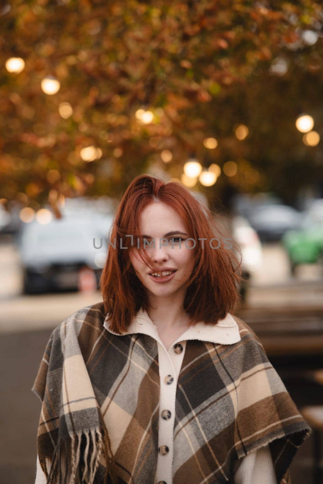 An alluring red-haired woman captivating with her bohemian style on an autumn day. by teksomolika
