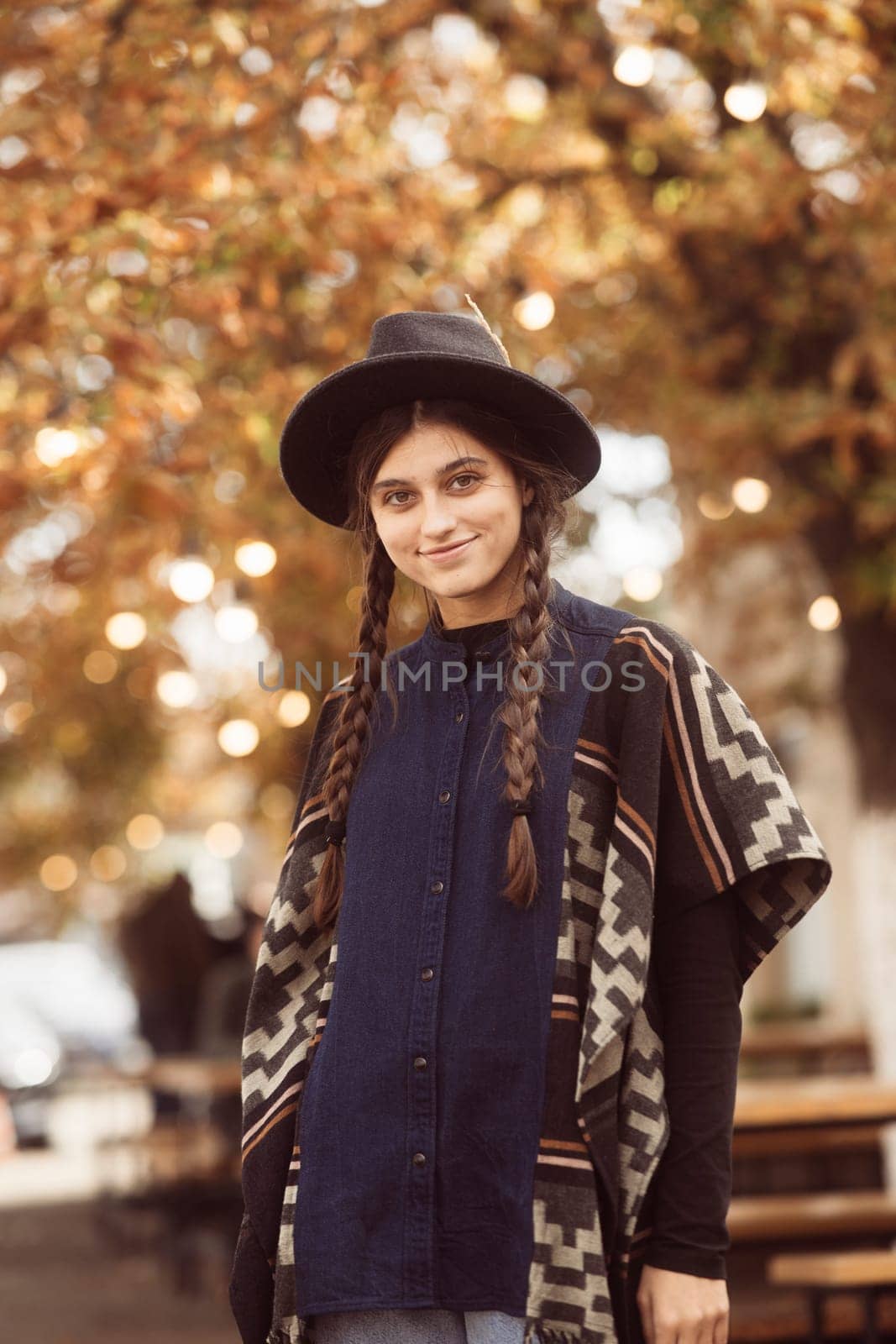 A chic lady exuding sophistication in black clothing and a hat. High quality photo