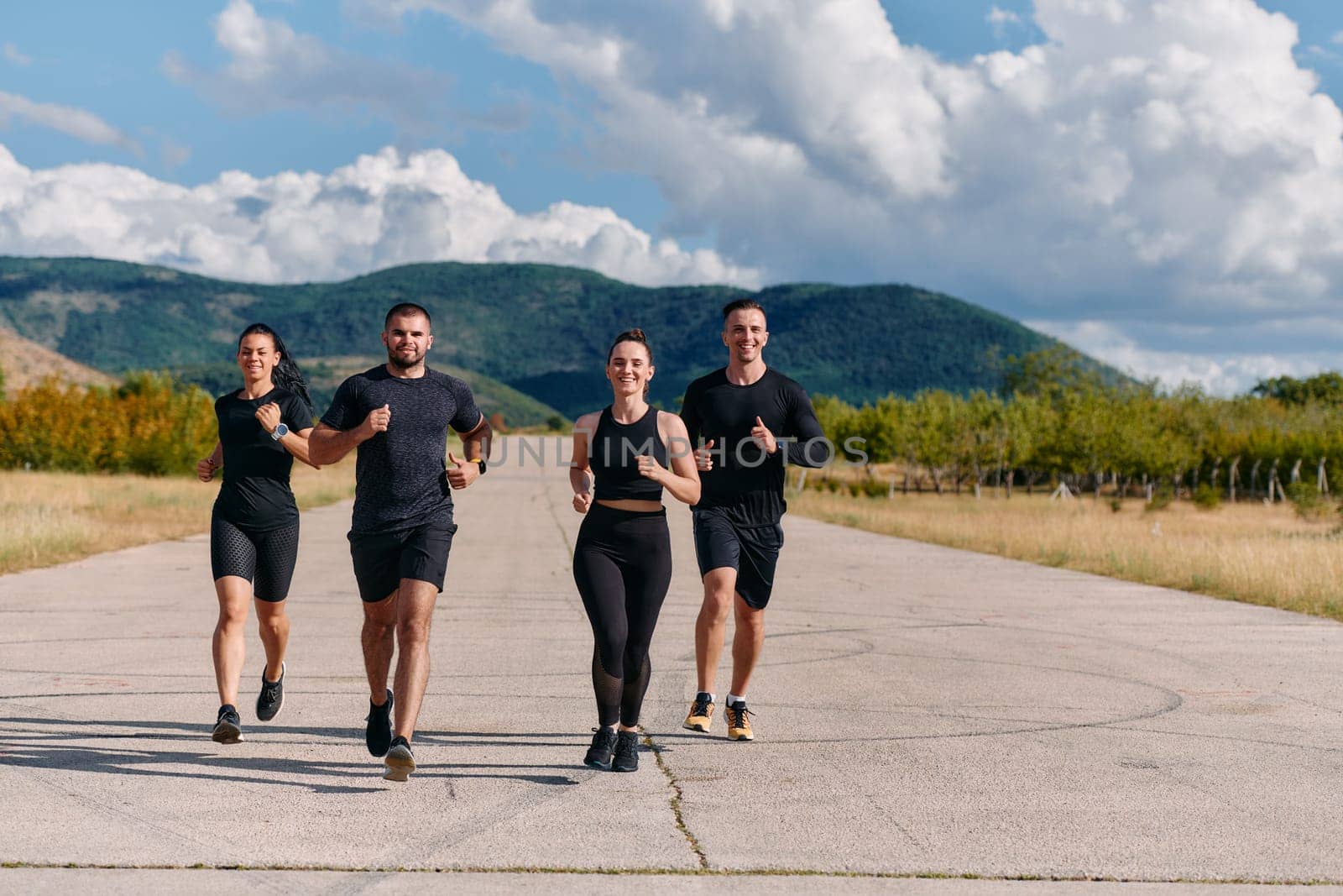 A professional athletic team as they train rigorously, running towards peak performance in preparation for an upcoming marathon.