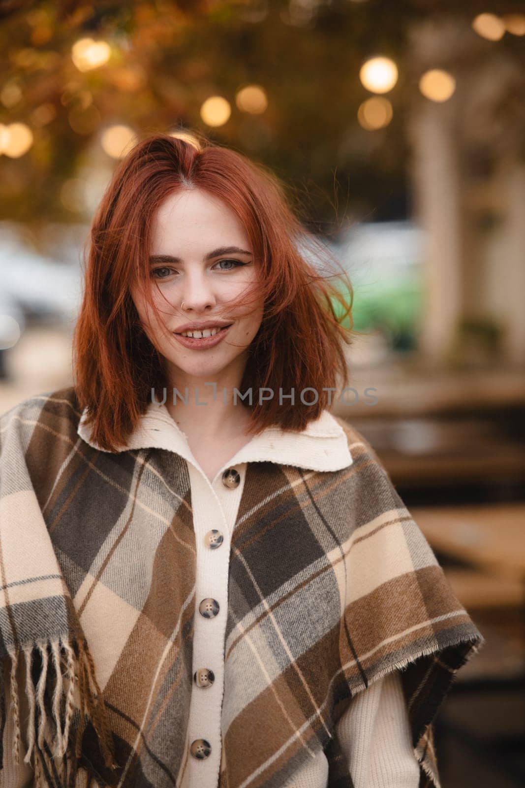 A striking redhead embodying the free-spirited essence of hippie culture in autumn. High quality photo