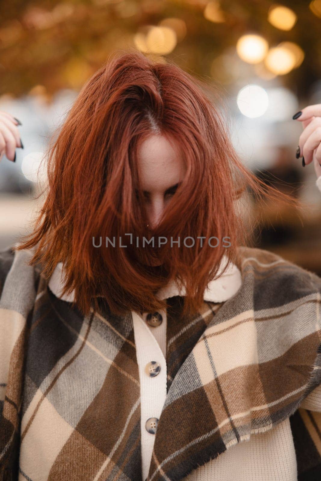 A lively redhead captivating attention with her hippie ensemble on an autumn day. High quality photo