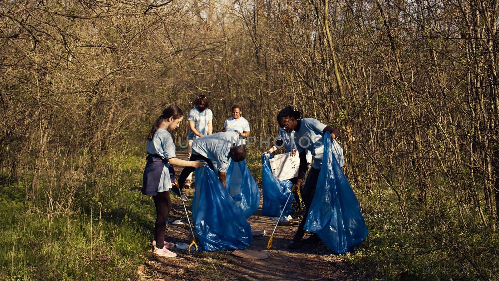 Group of volunteers working to clean the forest from garbage by DCStudio