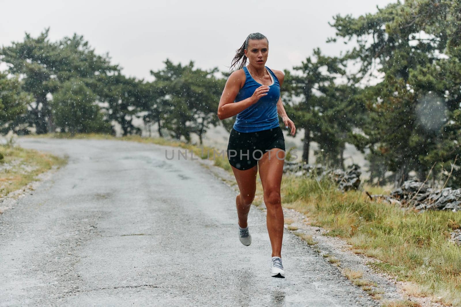 Rain or shine, a dedicated marathoner powers through her training run, her eyes set on the finish line.