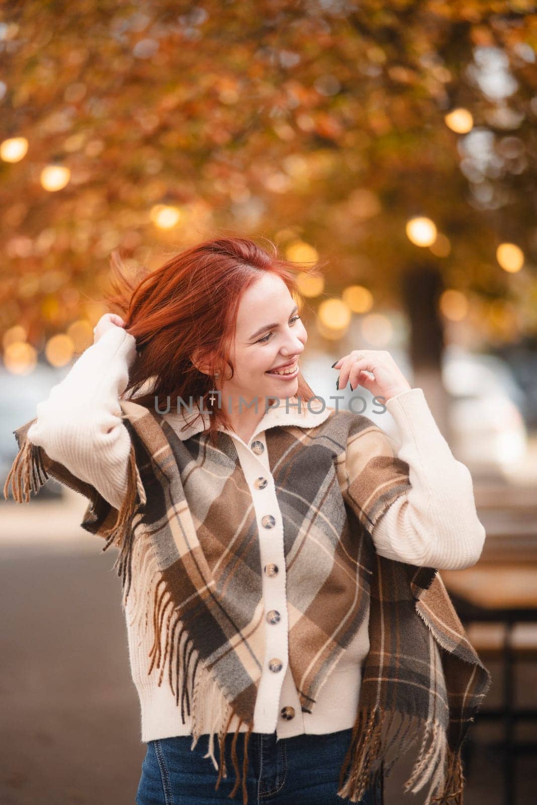 A sunny red-haired woman giggles with glee, infusing the autumn city with joy. by teksomolika