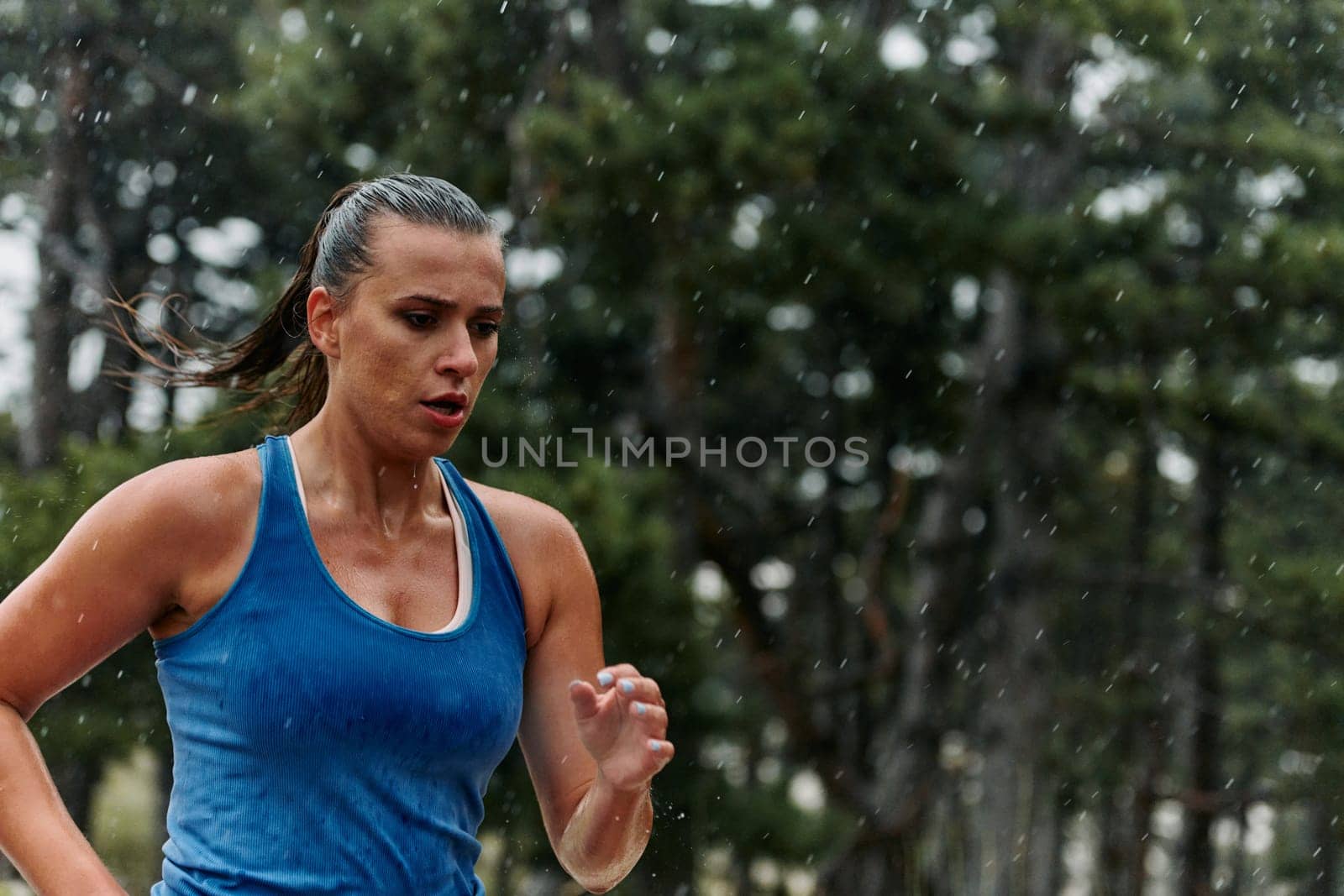 Rain or shine, a dedicated marathoner powers through her training run, her eyes set on the finish line.