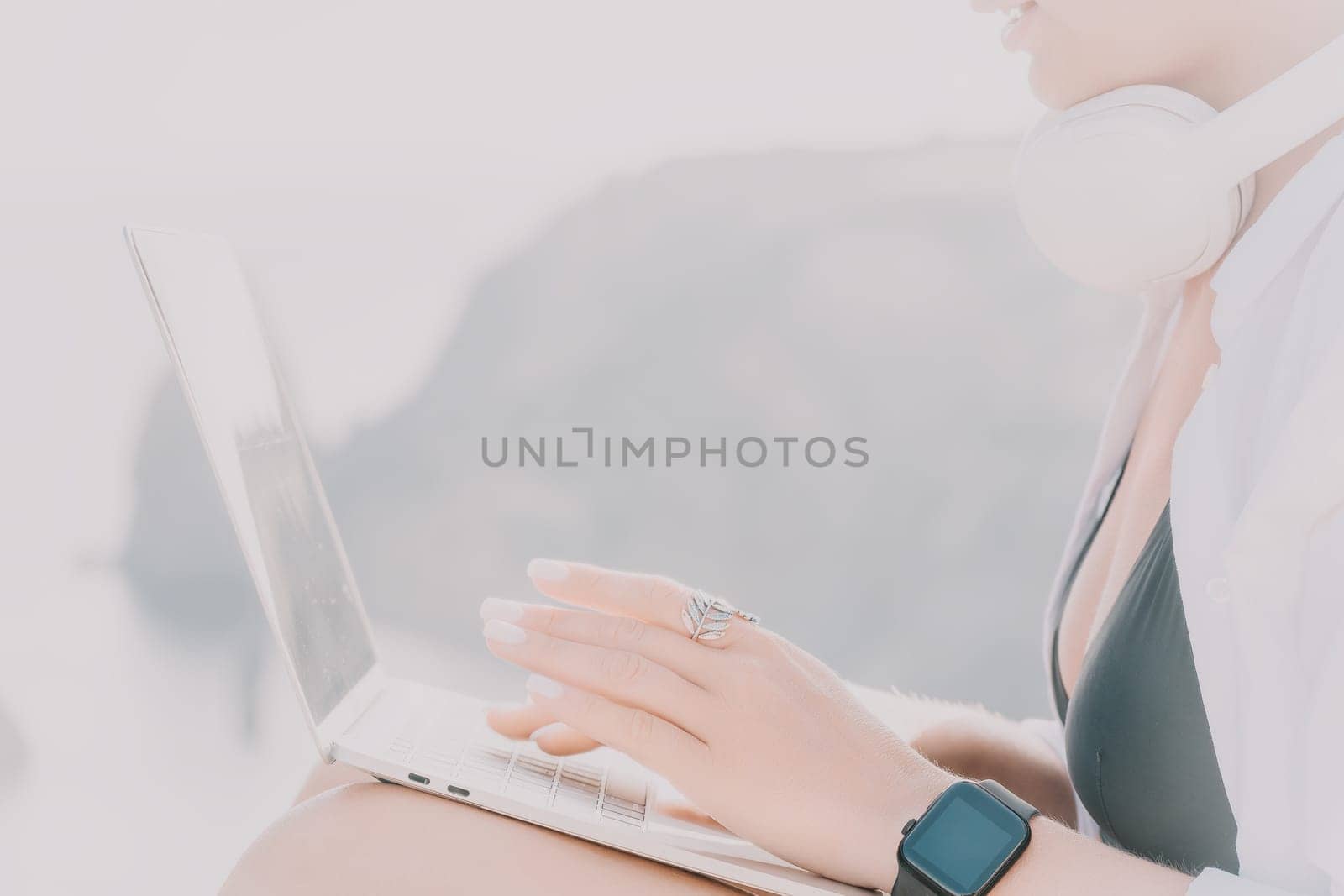 Woman sea laptop. Business woman, freelancer with laptop working over blue sea beach. Happy smiling girl relieves stress from work. Freelance, remote work on vacation, digital nomad, travel concept by panophotograph