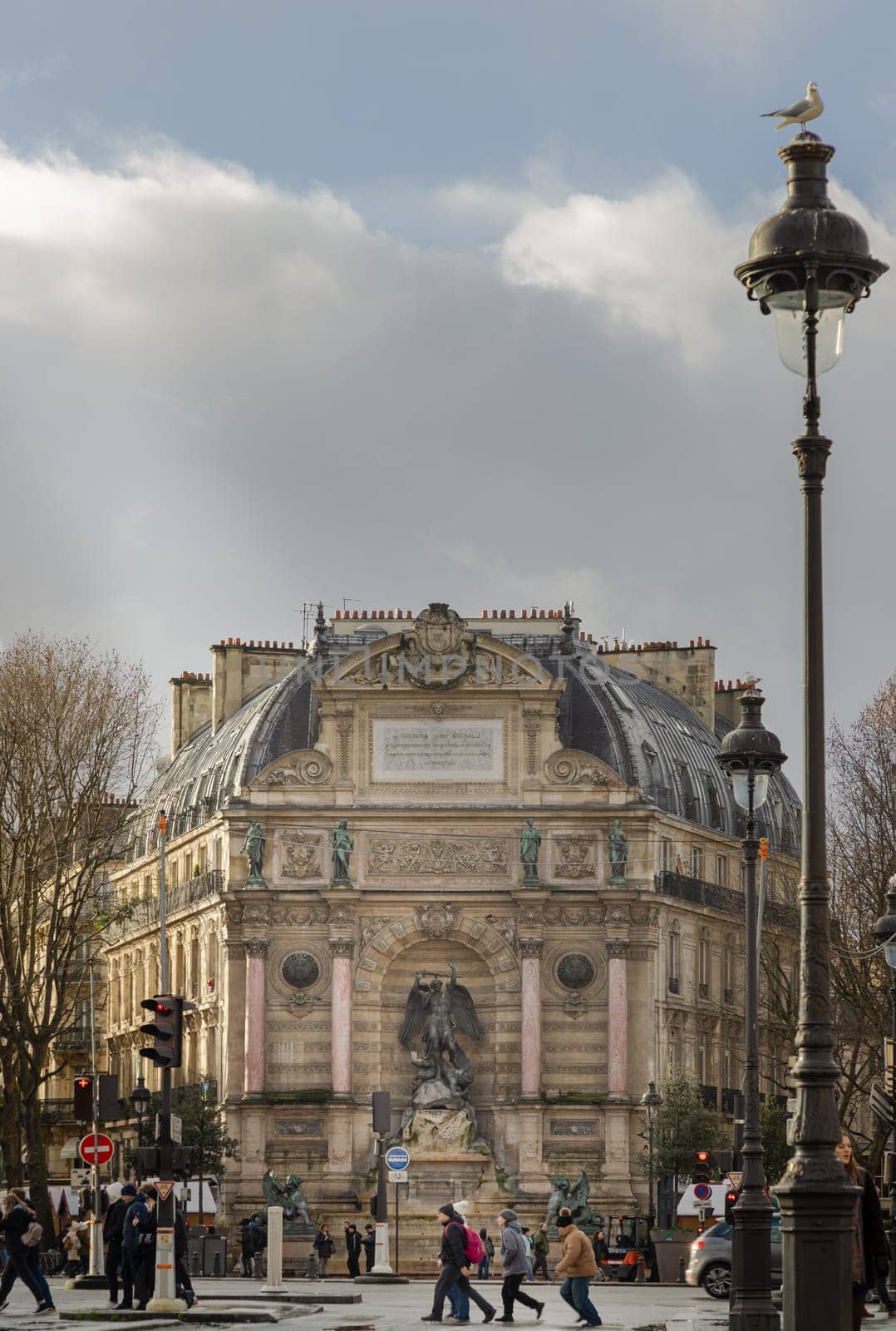 France, Paris - Jan 03, 2024 - Exterior Architecture and Old building design of The Fontaine Saint-Michel with Sculpture of Saint Michael slaying the Devil. City of Paris, Space for text, Selective focus.