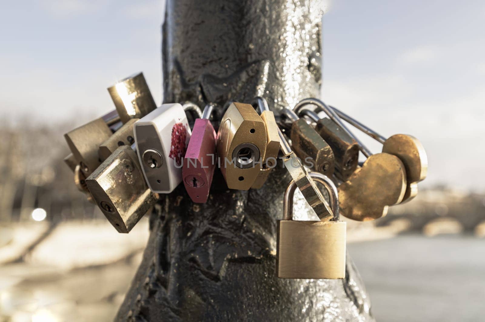 France, Paris - Jan 03, 2024 - Many padlocks locked on black steel pillar on the bridge. Love locks attached together for love wishes, Symbol of constant love and durability of the relationship, Crowded Love Padlocks, Space for text, Selective focus.