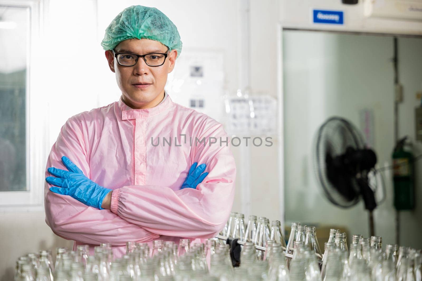 A man in a lab coat and blue gloves